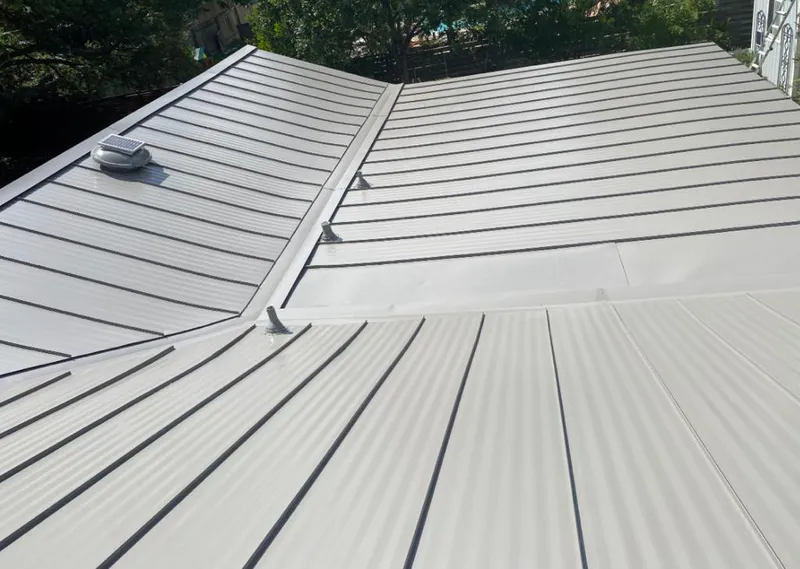 Solar attic fan installed on a metal roof for Roof Ventilation in Coralville